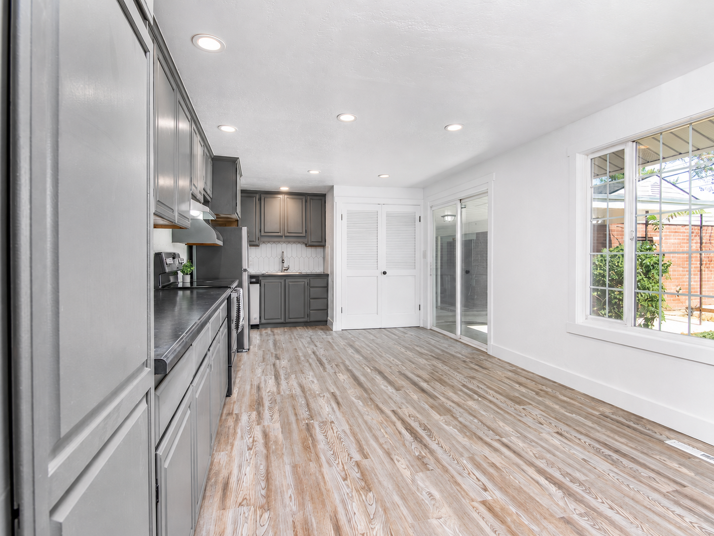 Finished kitchen and dining space with painted white walls, ceiling, and trim